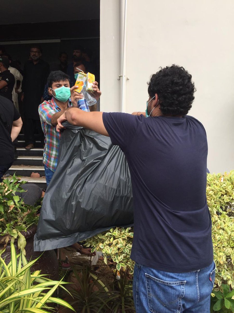 People at the protest have brought trash bags and are collecting litter outside the CBC office