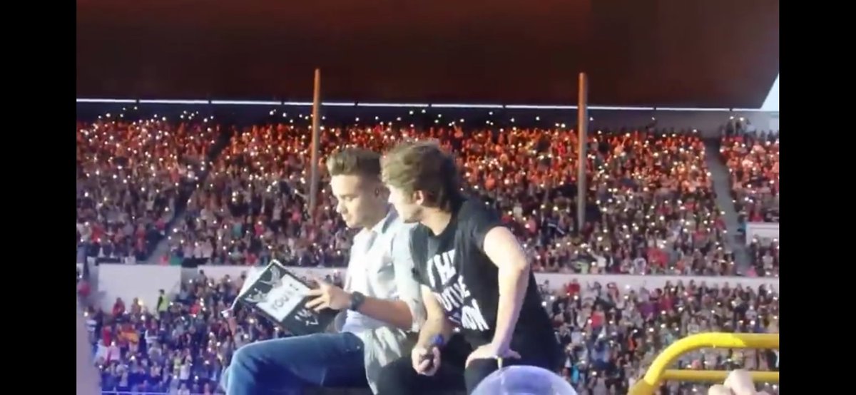 at first the others were singing and only Iiam was reading the book, then Iiam looked at Iouis and he joined him