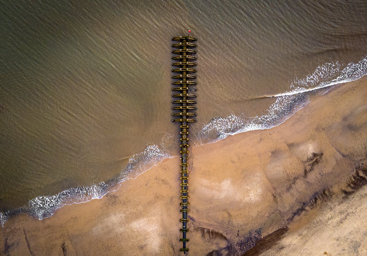 A drone shot from the coast. This pipe outlet looked like a giants spine or something. 
<a href="/DJIGlobal/">DJI</a>