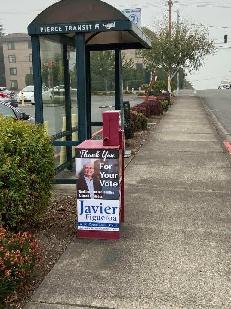 But the Tacoma Weekly hasn’t just provided a glowing cover story (political advertisement) for Figueroa, they are also featuring his picture on their newspaper boxes around Tacoma! /10