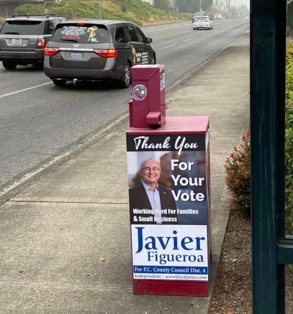 But the Tacoma Weekly hasn’t just provided a glowing cover story (political advertisement) for Figueroa, they are also featuring his picture on their newspaper boxes around Tacoma! /10