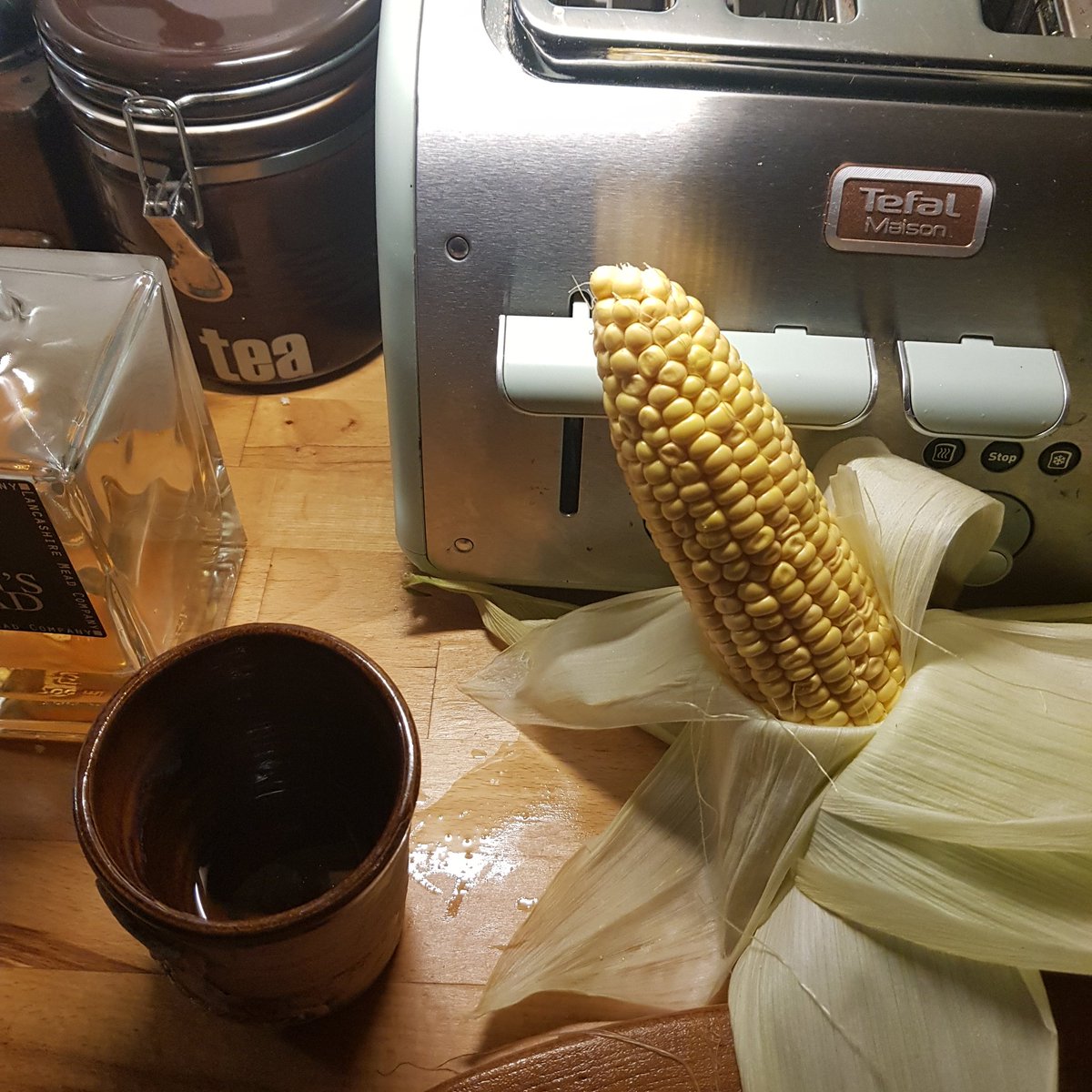 Corn on the cob desilked, taken the fluffy bits off the inside, and smothered with garlic butter before rewrapping. May, possibly, have overdone the garlic butter, but hey, it's all good for social distancing.