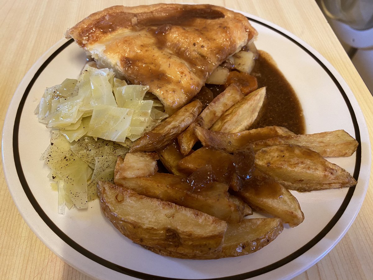 Meat and Potato pie with puff pastry top, chips, cabbage and gravy proper comfort food tonight