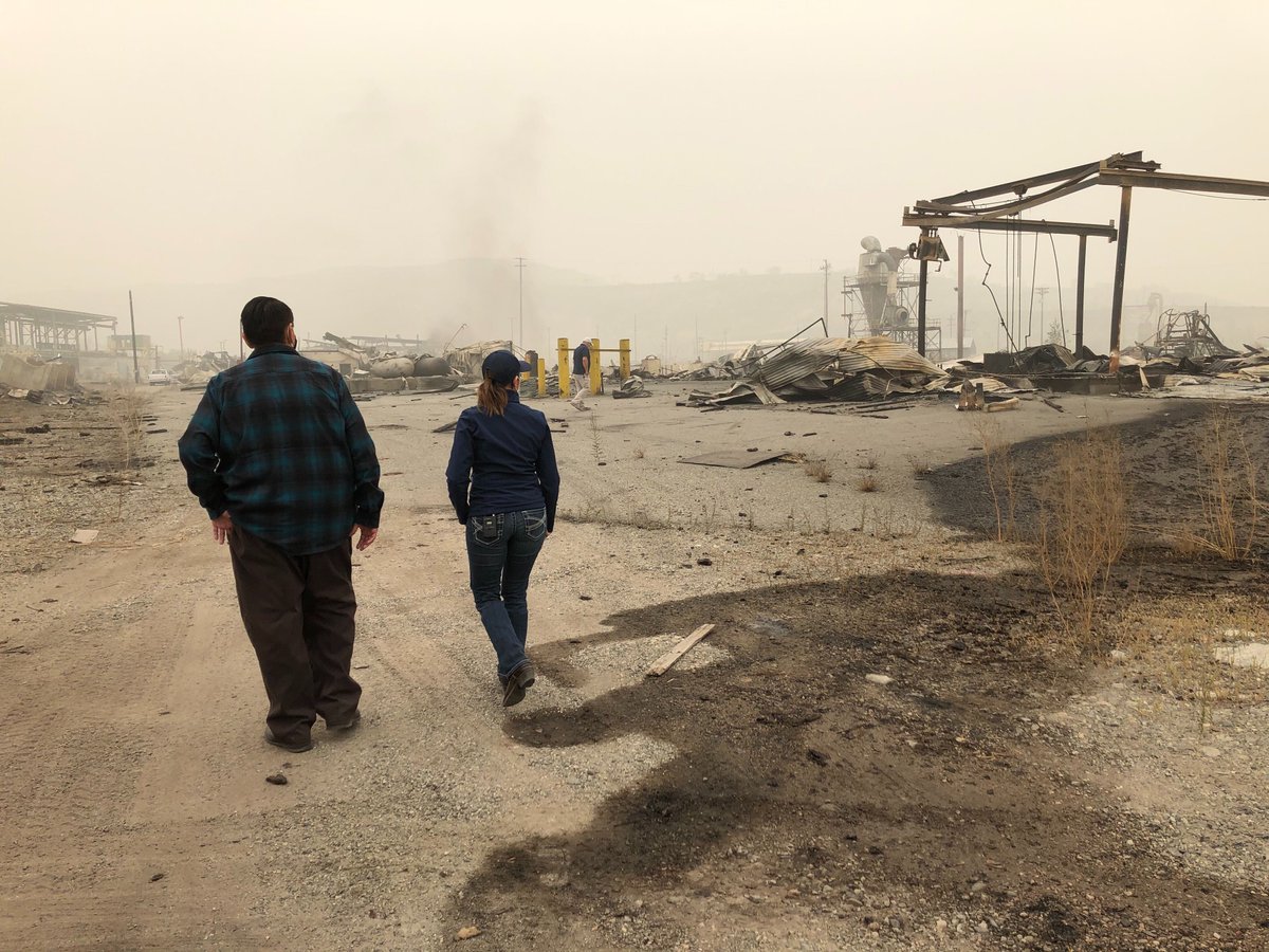 CPL_Dave's tweet photo. During the initial attack, several structures and outbuildings suffered damage or were lost, including the mill owned by Colville Tribes. Below, Chairman Rodney Cawston and I walk through the mill site. #WaWILDFIRE #ColdSpringsFire https://t.co/9iv3sC4sEE