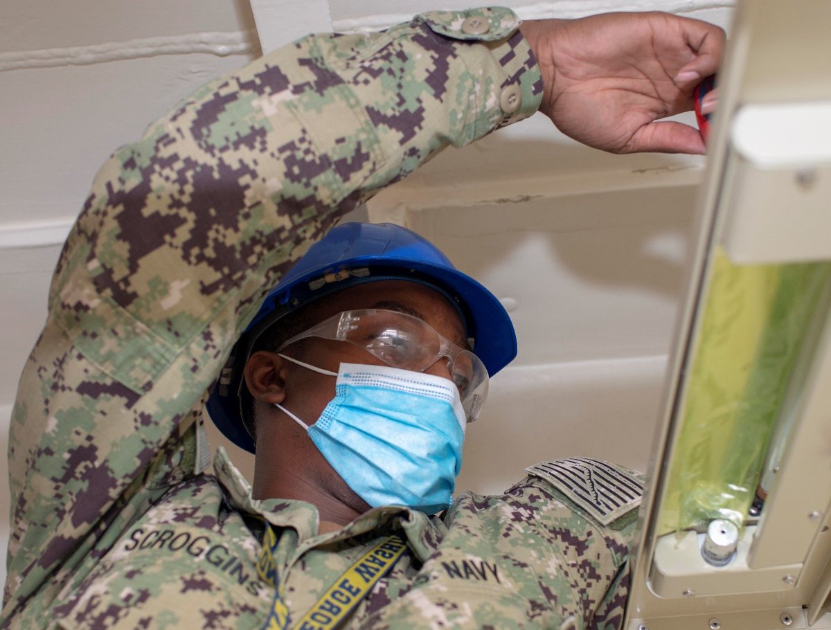 Airman Recruit Jatorius Scroggins, assigned to the berthing rehabilitation team aboard the Nimitz-class aircraft carrier USS George Washington (CVN 73), installs a rack light in one of the berthing compartments. (U.S. Navy photo by MC1 Patrick Grieco/Released)