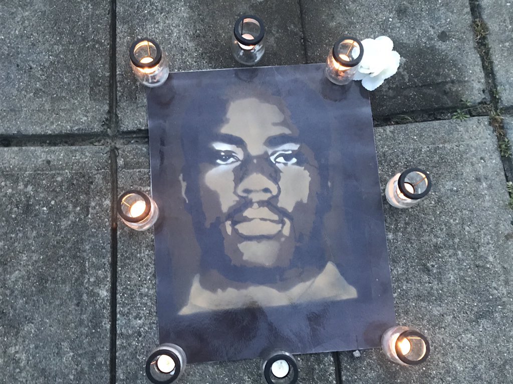 AlexGilesNews's tweet photo. A poster of #JonathanFerrell surrounded by candles @WBTV_News https://t.co/j9f73eVslU