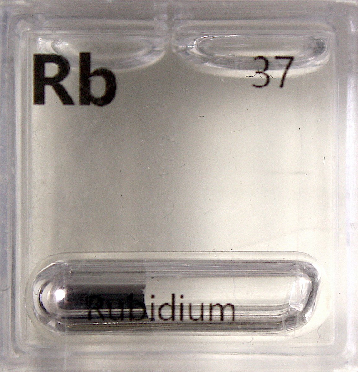 Rubidium  #elementphotos. True colour is silver-grey, but seems to take on a bronze colour in the smaller ampoules, perhaps in the sealing process. Rb melting point is just 39 °C. White compound is rubidium chloride (RbCl).