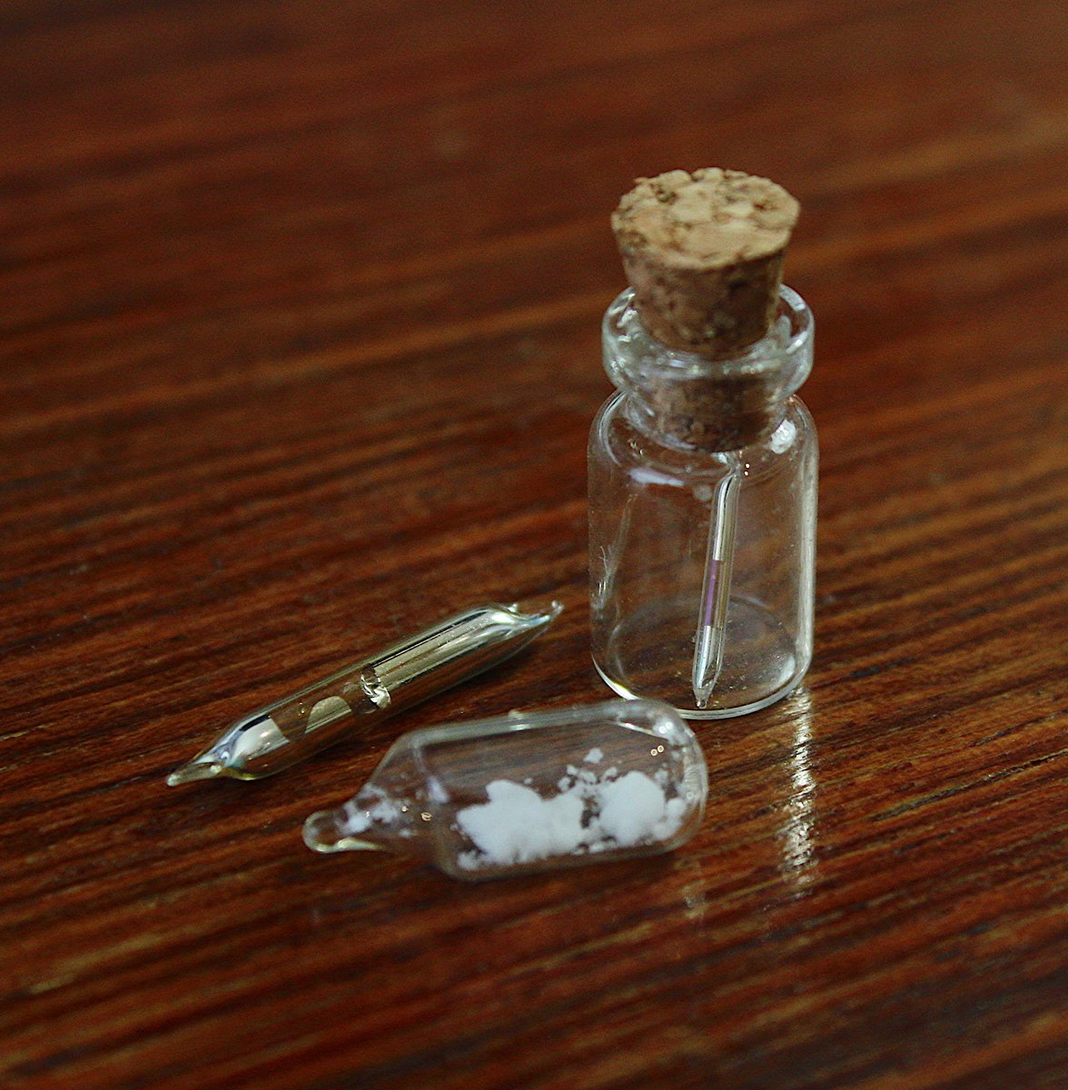 Rubidium  #elementphotos. True colour is silver-grey, but seems to take on a bronze colour in the smaller ampoules, perhaps in the sealing process. Rb melting point is just 39 °C. White compound is rubidium chloride (RbCl).