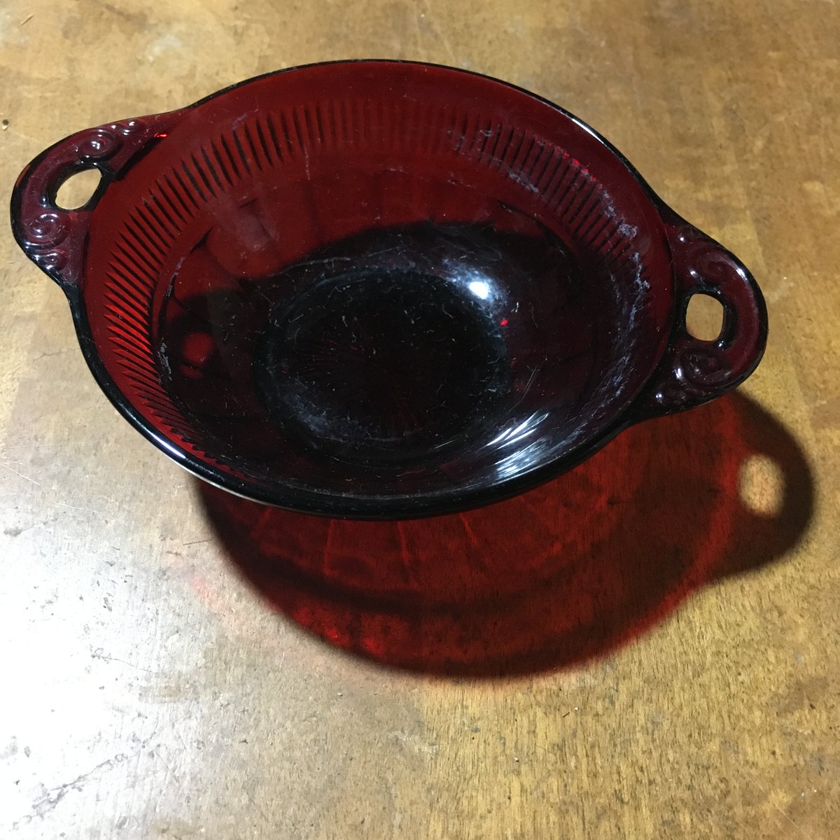 This little ruby red trinket dish is one piece I've been able to date: 1940s dessert dish, Anchor Hocking Co, Coronation pattern.