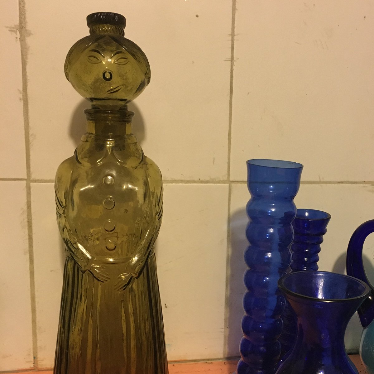 Ok, my friends in Italy; help me out with this one: what and when is this snarky green glass lady-shaped bottle from?!?!?
