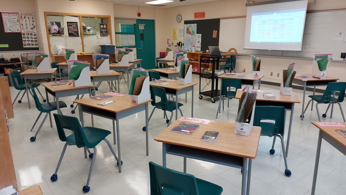 MmeCritch's tweet image. Sort of got 1 metre between each desk for a class of 18 juniors! Problem is... no safe pathway back to my own desk! Hello, face shield that makes a green house effect around my face 😷🥵#myclasssizeis #COVID19Ontario