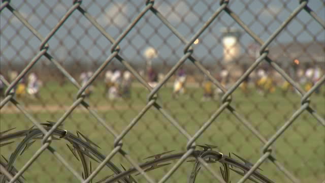 The camp is protected by fences and barbed wire, preventing any escapes. Watch towers looming over the scene  #Xinjiang