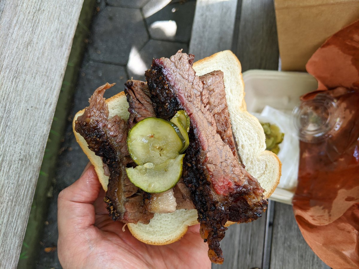 Beef brisket sandwich from Hill Country eaten on a park bench in Madison Square