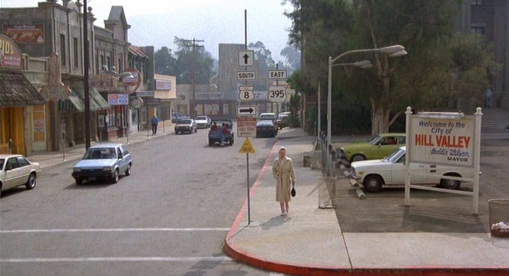 By 1985 downtown Hill Valley is shown as run down. The green town square is now a parking lot. There is even an adult novelty store & the small theater is showing XXX movies. Downtowns across America had a hard time competing with another 1950's invention: The Shopping Mall.