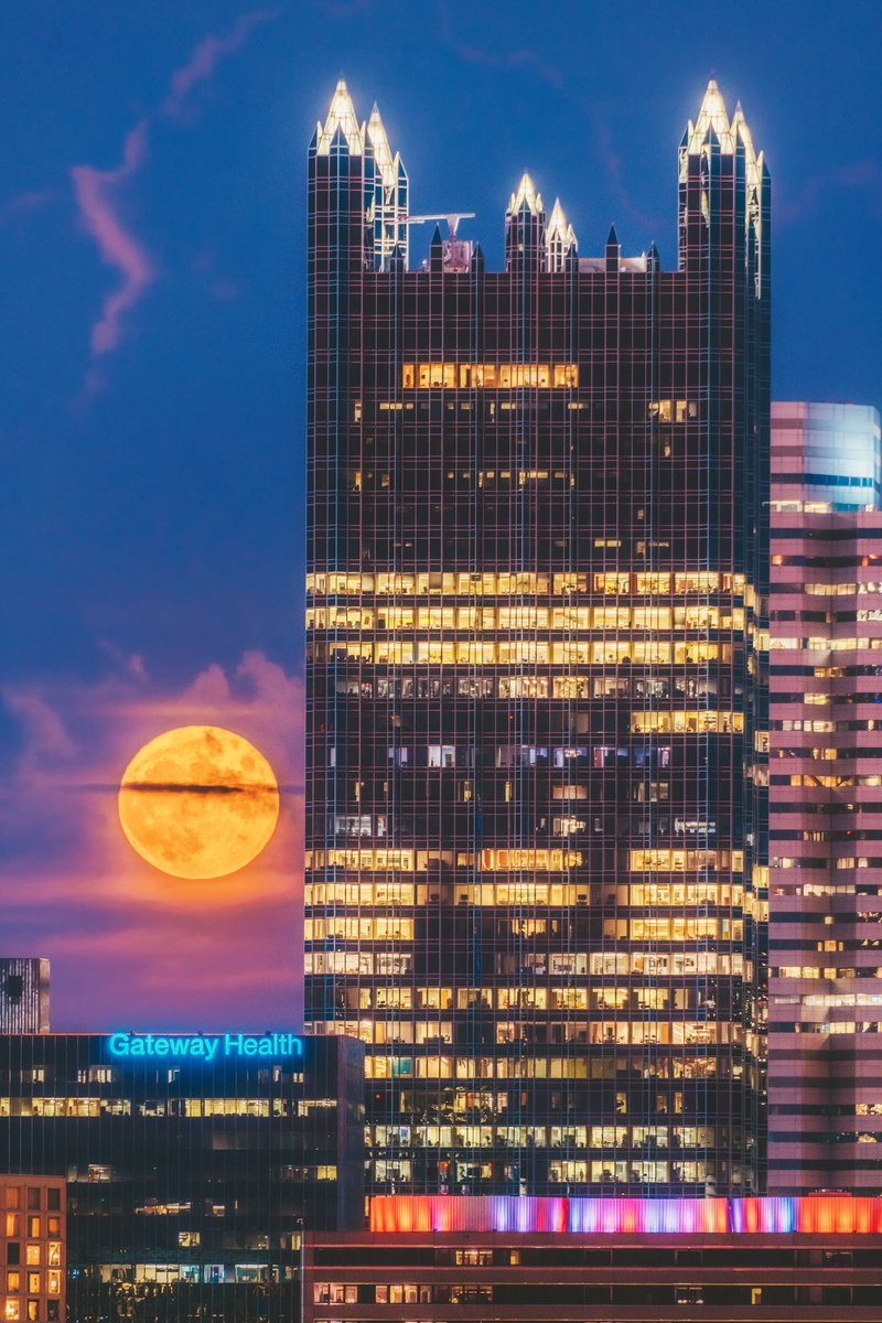DaveDiCello's tweet photo. Even before it reached the spires of PPG Place, the moon looked incredible glowing behind #Pittsburgh a few nights ago. With a veil of clouds in front of it lit up a soft purple, and a thin band of clouds across the middle, it contrasted perfectly with the deep blue dusk sky. https://t.co/5tumGULgdt