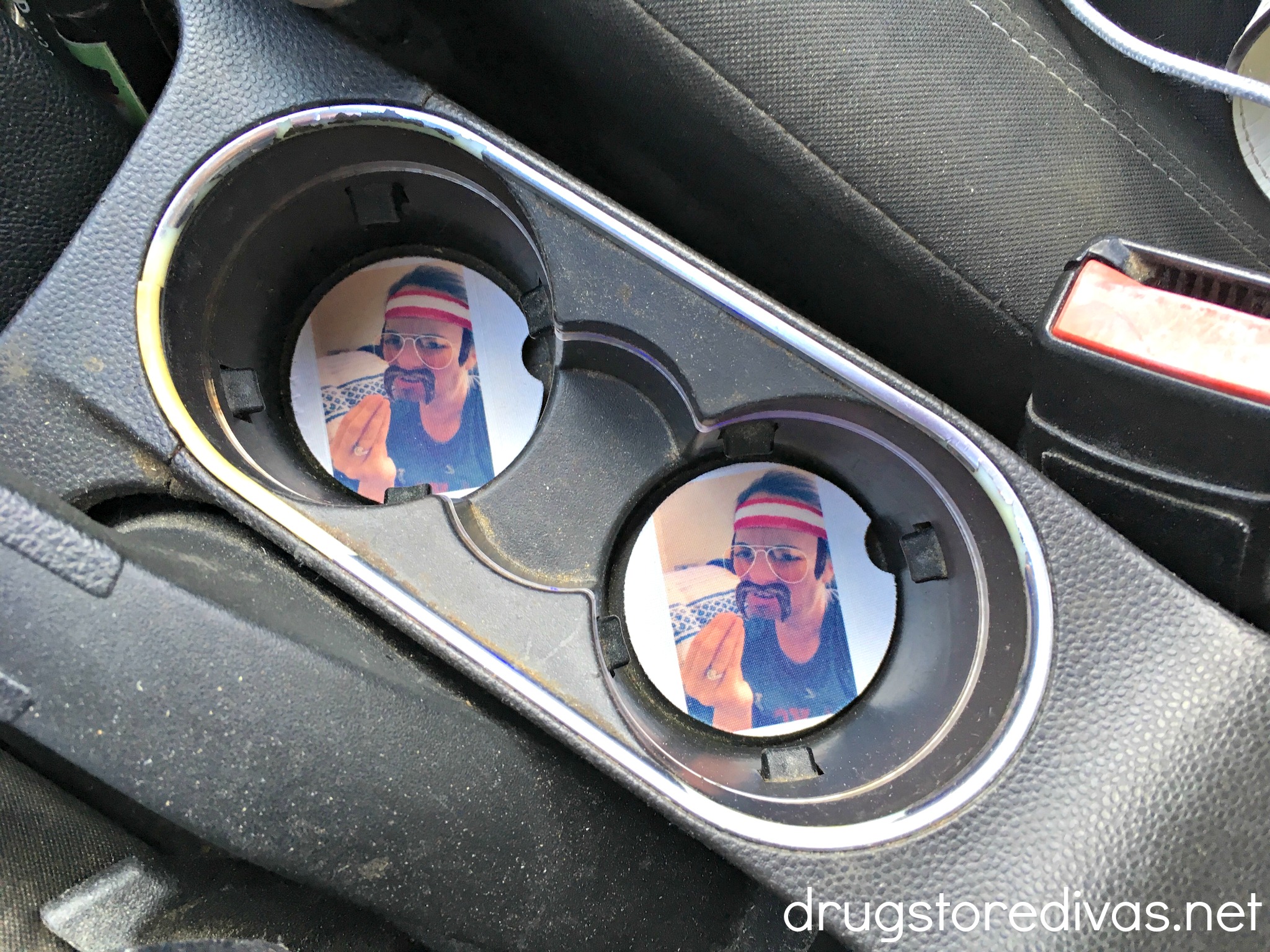 Personalized car coasters in a car.