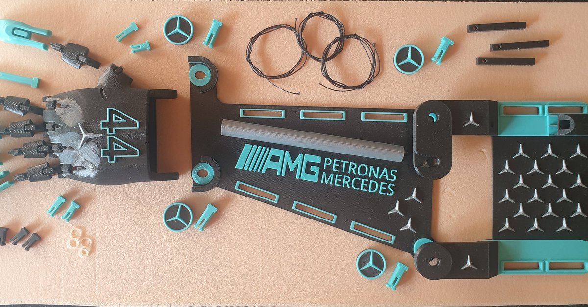 De-constructed 3d printed  prosthetic AMG arm designed for the 70th anniversary for Silverstone, to be mounted on a carbon board &amp; framed showing the components that go into each arm, roughly around 40 hours to print this piece and about 15 hours fine painting and assembly