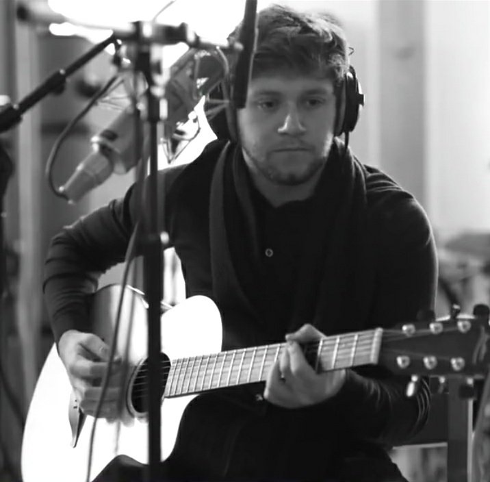 Black and White pictures of Niall wearing headphones while recording songs 