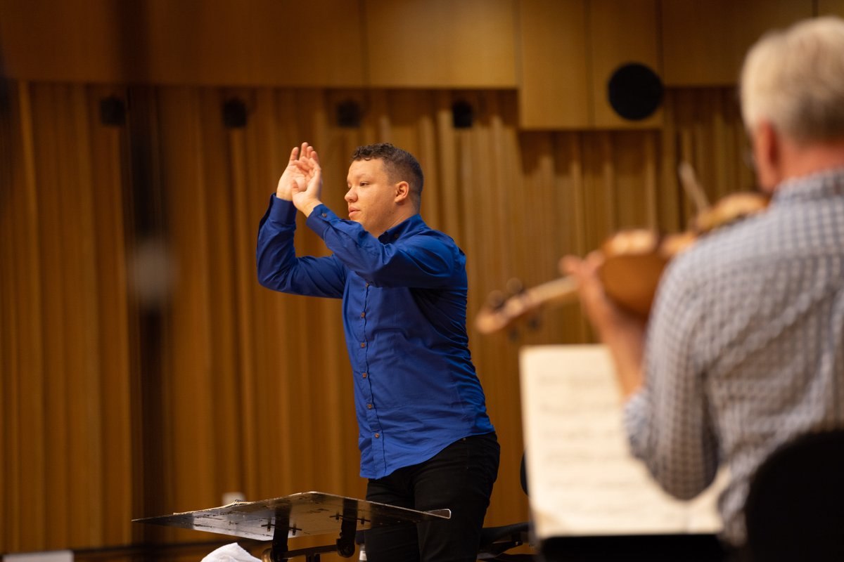 BBCNOW's tweet photo. Rehearsals are in full swing here in Hoddinott Hall and it is absolutely brilliant to have our new Principal Conductor, Ryan Bancroft, back with us! 👏

Our @bbcproms will be live streamed to @BBCiPlayer and broadcast to @BBCRadio3 on September 8th at 7.30pm 🎶

 Don't miss it!🤩 https://t.co/MmDy1rTs8q