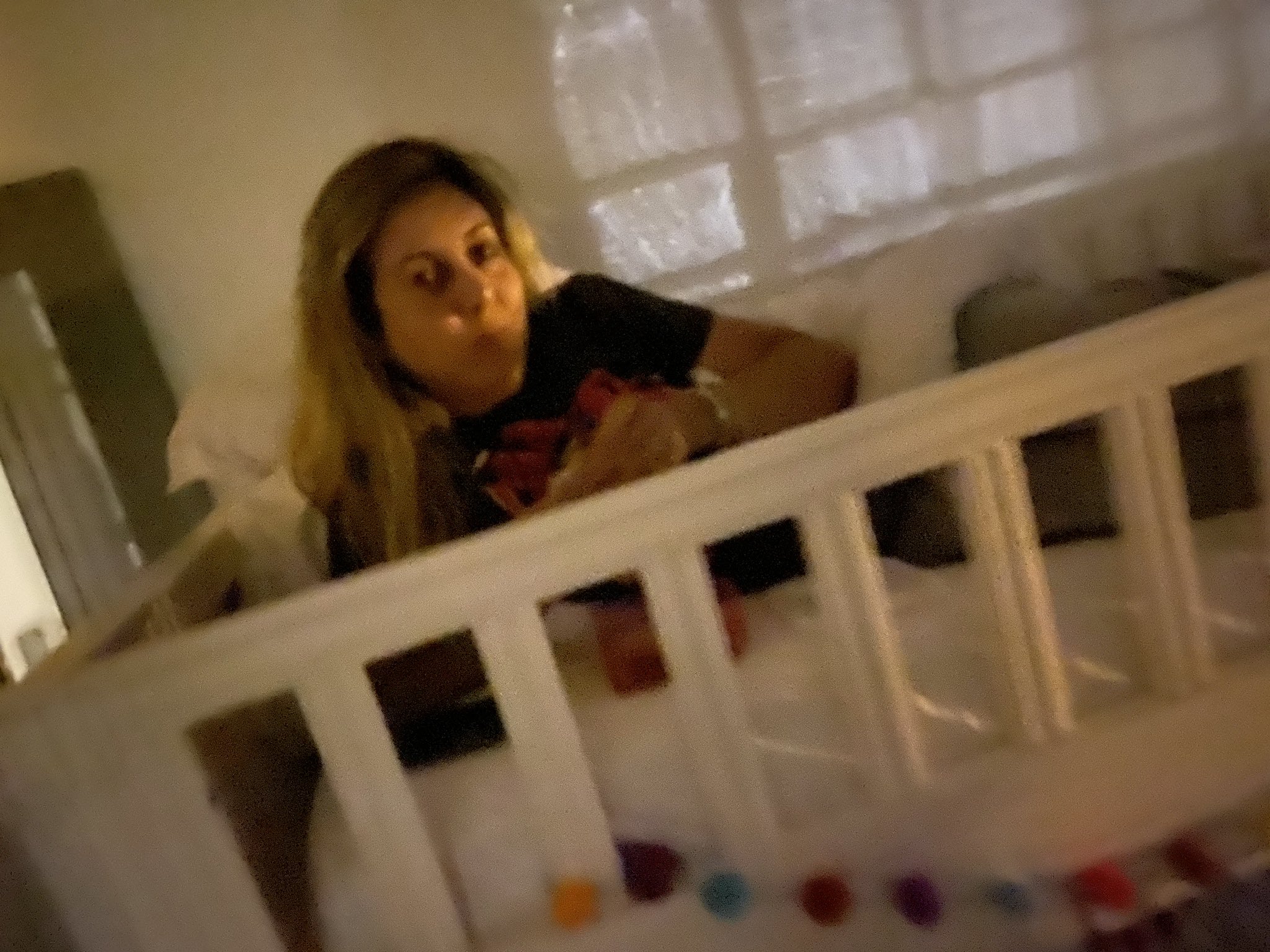 Mom sleeping in crib with clearance baby