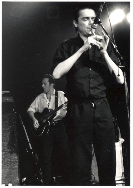 TheAaronChapman's tweet photo. Came across this photo today from my friend Cecilia Nord who got this nice shot of @spiderstacy with @JoeStrummer in the back, when the @poguesofficial played the @commodorevcr in 1987. Locals the Nervous Fellas opened. 
#LiveAtTheCommodore. https://t.co/XNYGiJISg1