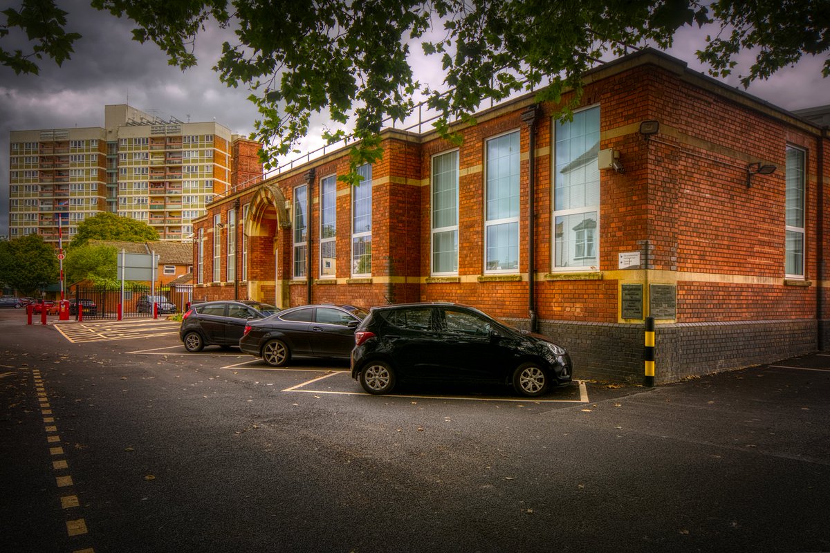 9/12 Clapham Court (#3) rising behind Gloucestershire Heritage Hub. In 1780 the area where the tower block now stands was called Monkleighton and straddled the city boundary. By 1852 streets had been laid out and working-class houses built. Cleared and tower built 1963.