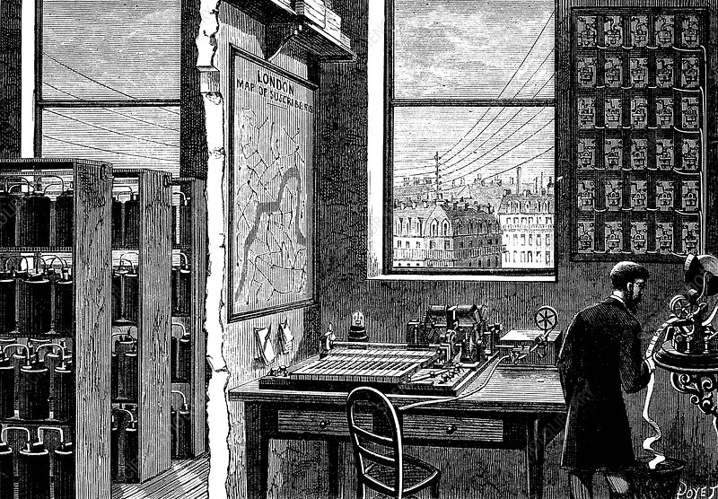 So, Extel had one telegrapher on the trading floor who sent prices to Extel's HQ in Cornhill, from where they were transmitted to the whole system. Note 3 things in this pic: the batteries to the left, the circuit switchboard on the right, and the wires seen through the window