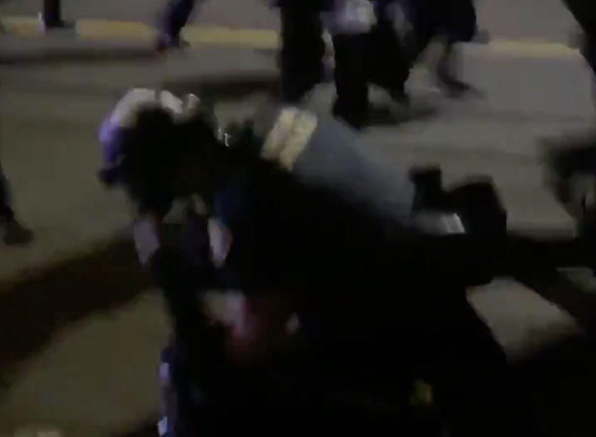Tyler Brett Cox, a nurse at  @OHSUNews hospital, was filmed pulling off the helmet of an officer at an  #antifa riot & getting punched while on the ground. He was dressed in black bloc. He was charged w/felony assault of an officer, resisting arrest & more.  https://archive.vn/aEAMK 