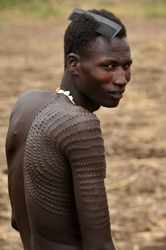 t3 a/ Nyagatom Man ( Ethiopia  & Sudan  ) with special scarification, which means he has killed many enemies.