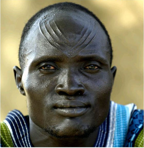 t6/ Reasons to Scar; Protection From DeathSpirituality plays an important role in African culture. Facial scarring is sometimes used to protect a person from death. Dinka Man Sudan 