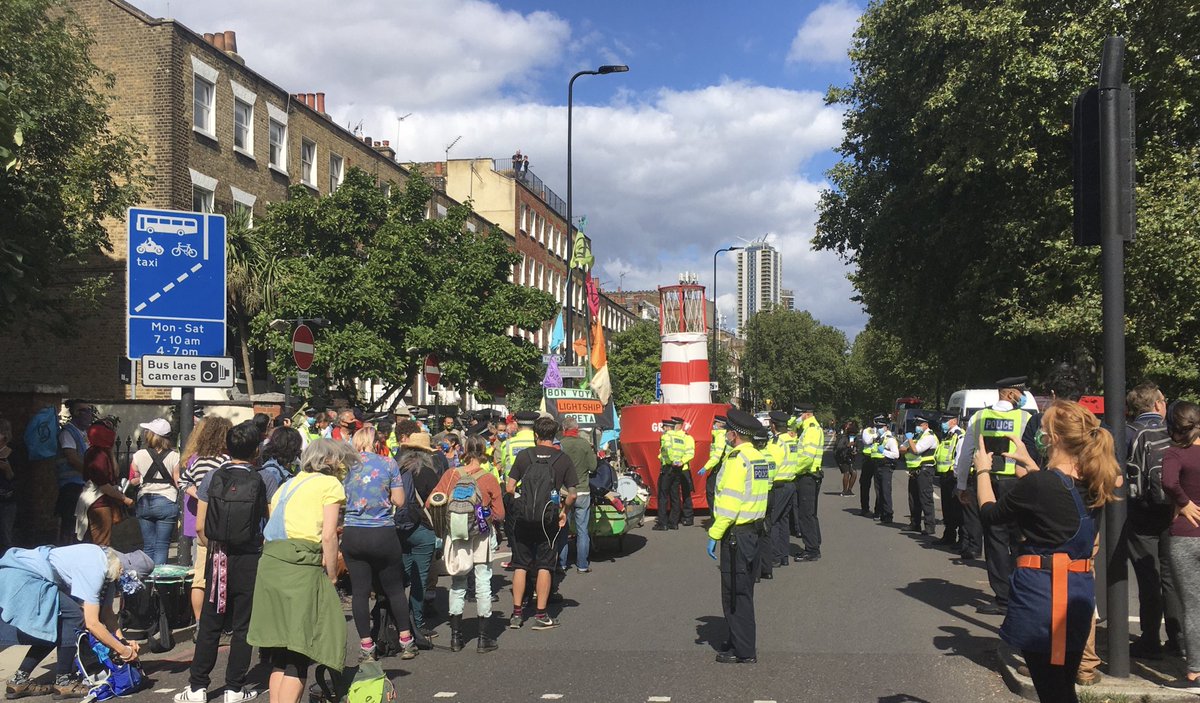 legalhackette's tweet photo. This seems a monster over-reaction by police to small number of protesters, mainly women &amp; children, with boat. They’re on Kennington Park Road - fewer than 50 protesters &amp; more than 12 police vans, a helicopter, motorcycles and cars. There’s about 5 police for every 1 protester. https://t.co/PfDVnnEZhw