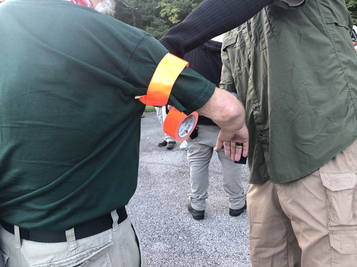 The NPDT Militia is putting on orange tape armbands to differentiate themselves from other militia groups on the ground.For the same reason, they were apparently instructed not to wear camo.Long guns will be out downtown. For now, sidearms only.
