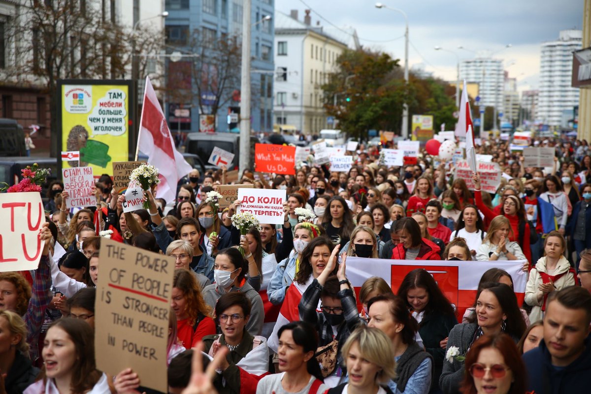 franakviacorka's tweet photo. Women's March in Minsk has begun. Women are holding flags of Belarus, Ukraine, Poland, Italy and other countries. Posters: "I am peaceful Belarusian woman", "Lukashenka is the social construct", "The power of people is stronger than People in Power". Photos: @svaboda https://t.co/jZBMVvtMod