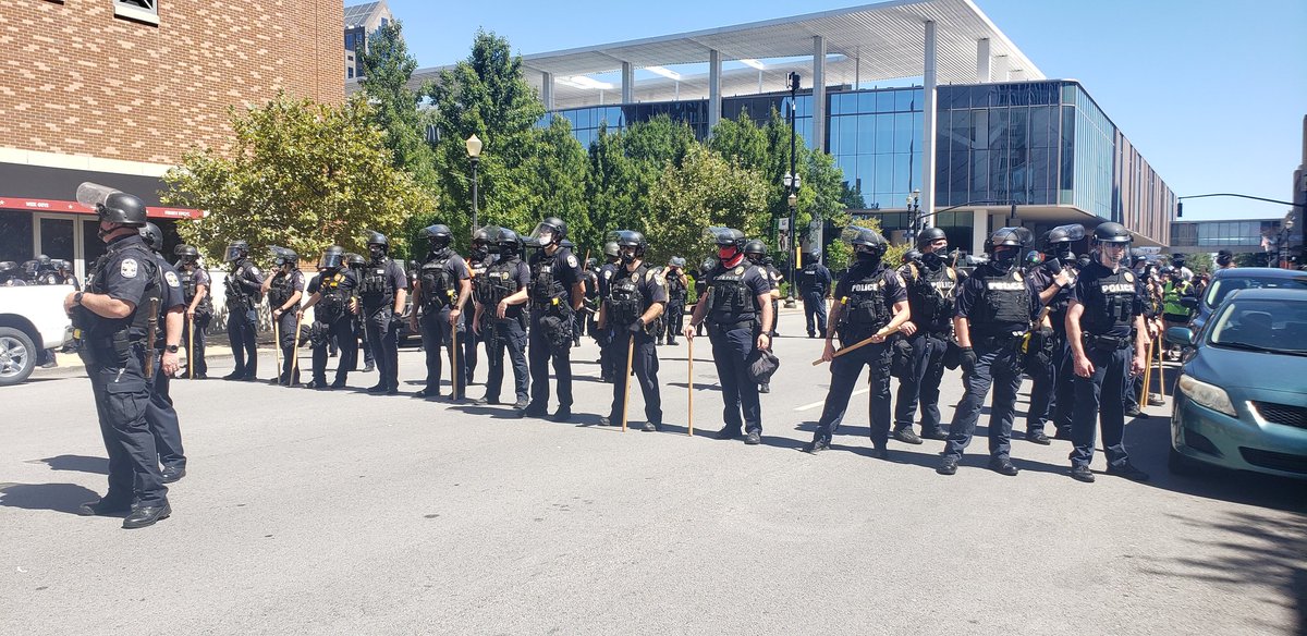 Louisville police are outfitted in riot gear with pepper ball guns and long clubs