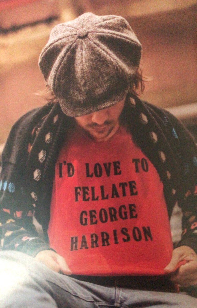 harry wearing a shirt that states how he’d LOVE to perform oral on George Harrison