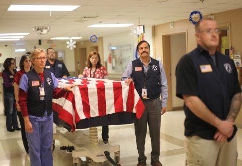 The Honors Escort is a solemn procession that occurs when a veteran passes. It begins with a bedside flag ceremony, then the gurney is draped with the American flag and a procession escorts the Veteran to the morgue in the basement. 2/