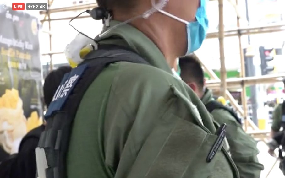 After one riot police demanded reporter of  @StandNewsHK to film from aside, another riot police stood right in front of her camera, blocking sight of the boy in black under search behind.