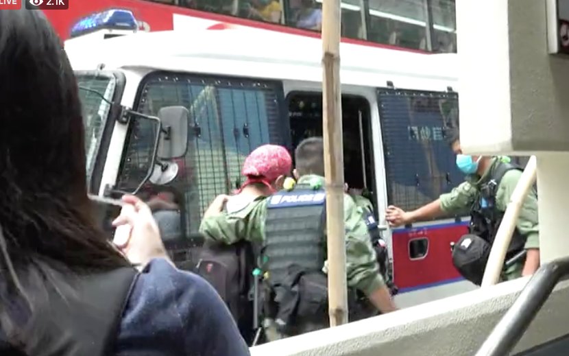 Two young men, including a boy in black and this man in grey, were taken onto a police van after search via  @StandNewsHK live.