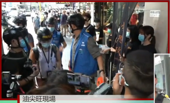 A number of Student Politicism members - seemingly secondary school students - are surrounded by police as they were handing out masks to passengers in Mong Kok