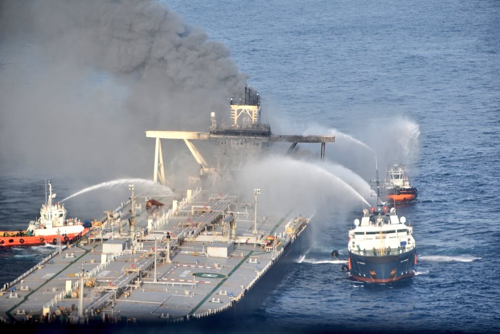 Defence_XP's tweet photo. #Aerial reconnaissance continuing & flames still visible with smoke emanating from superstructure. Air-Dropping of Dry Chemical Powder being undertaken..
#FirefightingatSea #IndianNavy https://t.co/HF6oXxZKCr