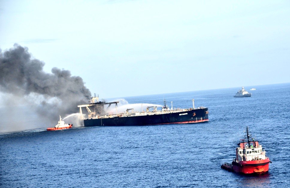 Defence_XP's tweet photo. #Aerial reconnaissance continuing & flames still visible with smoke emanating from superstructure. Air-Dropping of Dry Chemical Powder being undertaken..
#FirefightingatSea #IndianNavy https://t.co/HF6oXxZKCr