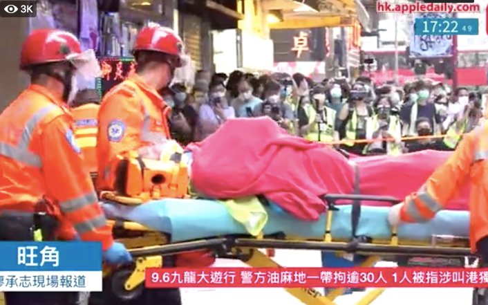 XinqiSu's tweet photo. The man in hivis vest and lost his consciousness on Shan Tung St wast just taken onto ambulance by paramedics. Bystanders were angrily shouting curses on police and their families. https://t.co/gZEDIGDXqG