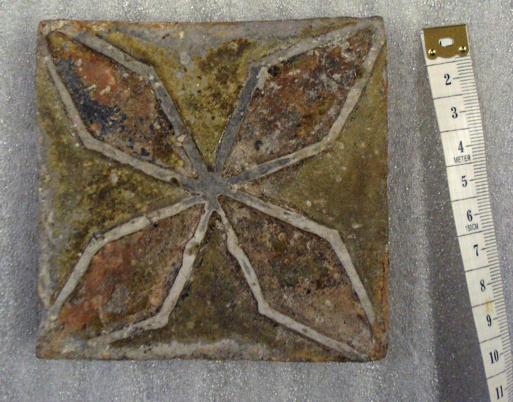 Surviving Medieval floor tiles. Note relief on two of the examples.