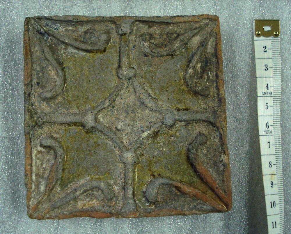 Surviving Medieval floor tiles. Note relief on two of the examples.