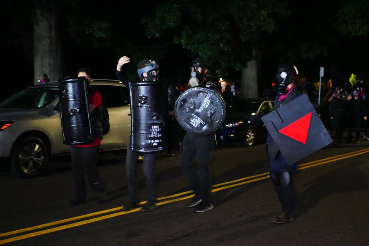 9/5 2301-2302 Protester raises his hands in front of advancing officers. Individual with speaker kneels as police pass. Shields pause ahead of the advance.  #pdxprotest  #BLM  #portland  #blacklivesmatter    #portlandprotest  #defendpdx  #BLMprotestsvideo:  https://twitter.com/BaghdadBrian/status/1302529592742141953