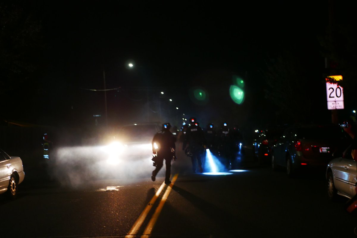 9/5 2312-2318 A third very agitated protester confronts police and is restrained briefly by others. Officers drop smoke as they retreat, press and protesters follow.  #pdxprotest  #BLM  #portland  #blacklivesmatter    #portlandprotest  #defendpdx  #BLMprotests