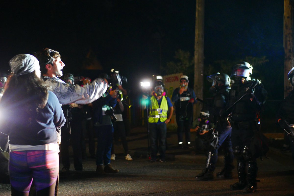 9/5 2312-2318 A third very agitated protester confronts police and is restrained briefly by others. Officers drop smoke as they retreat, press and protesters follow.  #pdxprotest  #BLM  #portland  #blacklivesmatter    #portlandprotest  #defendpdx  #BLMprotests