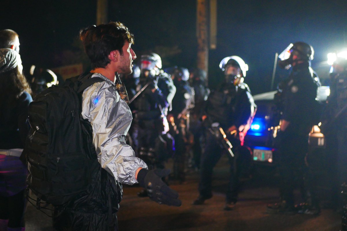 9/5 2312-2318 A third very agitated protester confronts police and is restrained briefly by others. Officers drop smoke as they retreat, press and protesters follow.  #pdxprotest  #BLM  #portland  #blacklivesmatter    #portlandprotest  #defendpdx  #BLMprotests