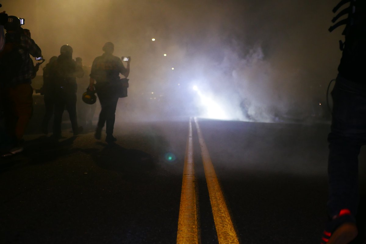 9/5 2312-2318 A third very agitated protester confronts police and is restrained briefly by others. Officers drop smoke as they retreat, press and protesters follow.  #pdxprotest  #BLM  #portland  #blacklivesmatter    #portlandprotest  #defendpdx  #BLMprotests