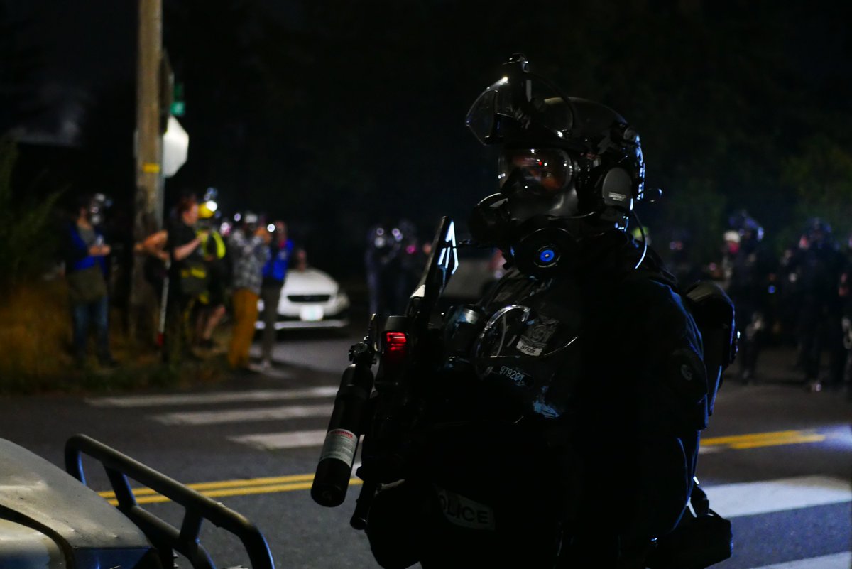 9/5 2328-29 An officer watches the protesters retreat again, looking for a shot. Behind him the police line waits, determining their next move. #pdxprotest  #BLM  #portland  #blacklivesmatter    #portlandprotest  #defendpdx  #BLMprotests